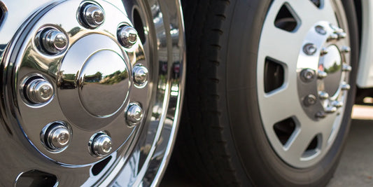 A comparison of aluminum polishing vs chrome polishing on two shiny truck wheels.