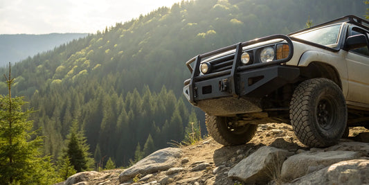A heavy-duty offroad bumper kit on a vehicle navigating a rocky trail.