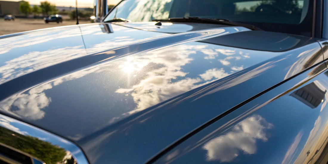 A truck hood's mirror finish after paint correction, a result that influences the final cost.