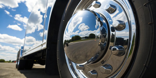A polished chrome hub cap for trucks with a clean, mirror-like finish.