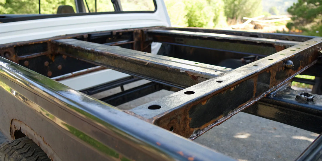 A rusty truck frame in need of cleaning and a new coat of protective rust paint.