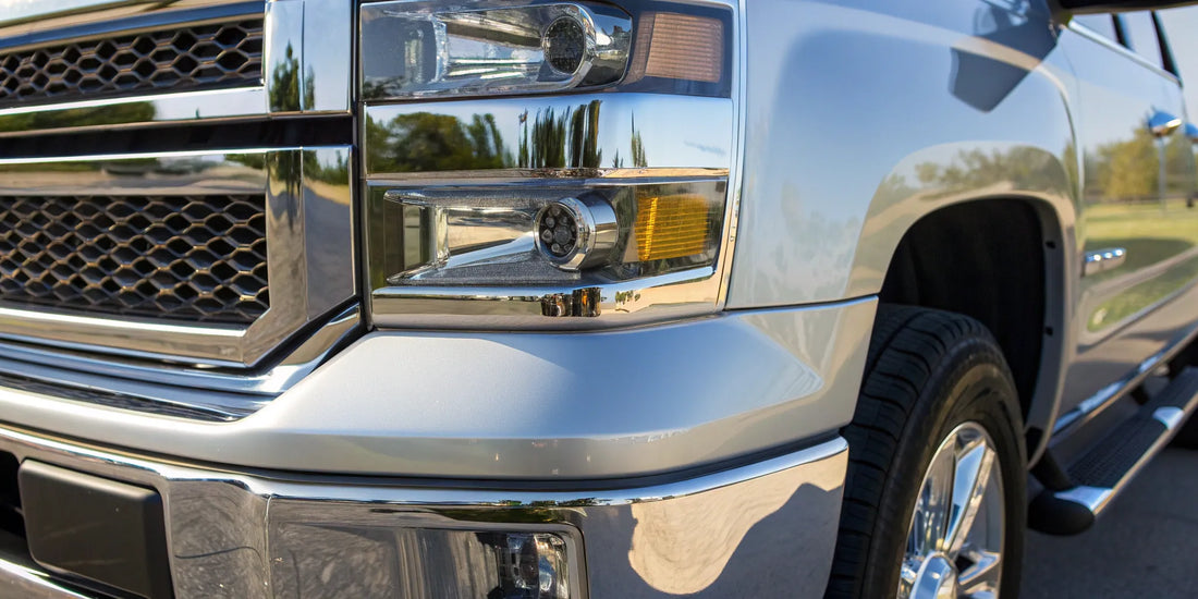 Rugged custom truck bumper in chrome with a matching grille and modern headlights.