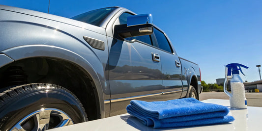 A professionally detailed silver truck sits next to the equipment used to determine truck detailing prices.