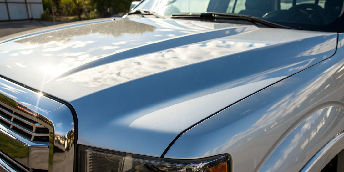 The mirror-like finish on a truck's hood after a professional paint correction.