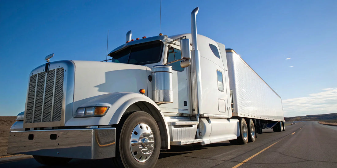 A white semi truck on the highway, ready to be sold to a we buy semi trucks buyer.