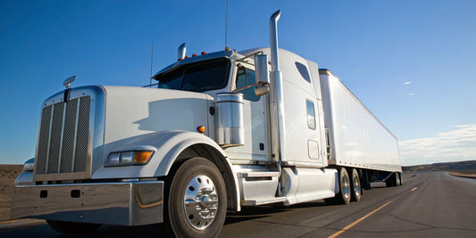 A white semi truck on the highway, ready to be sold to a we buy semi trucks buyer.