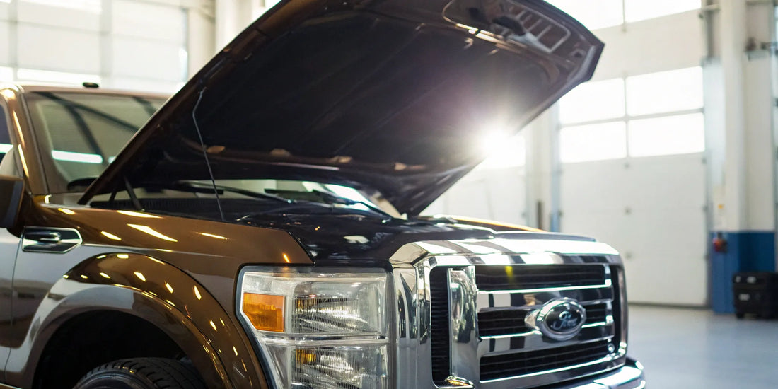 Commercial truck with its hood open for a DOT annual inspection.