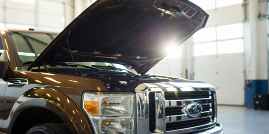 Commercial truck with its hood open for a DOT annual inspection.